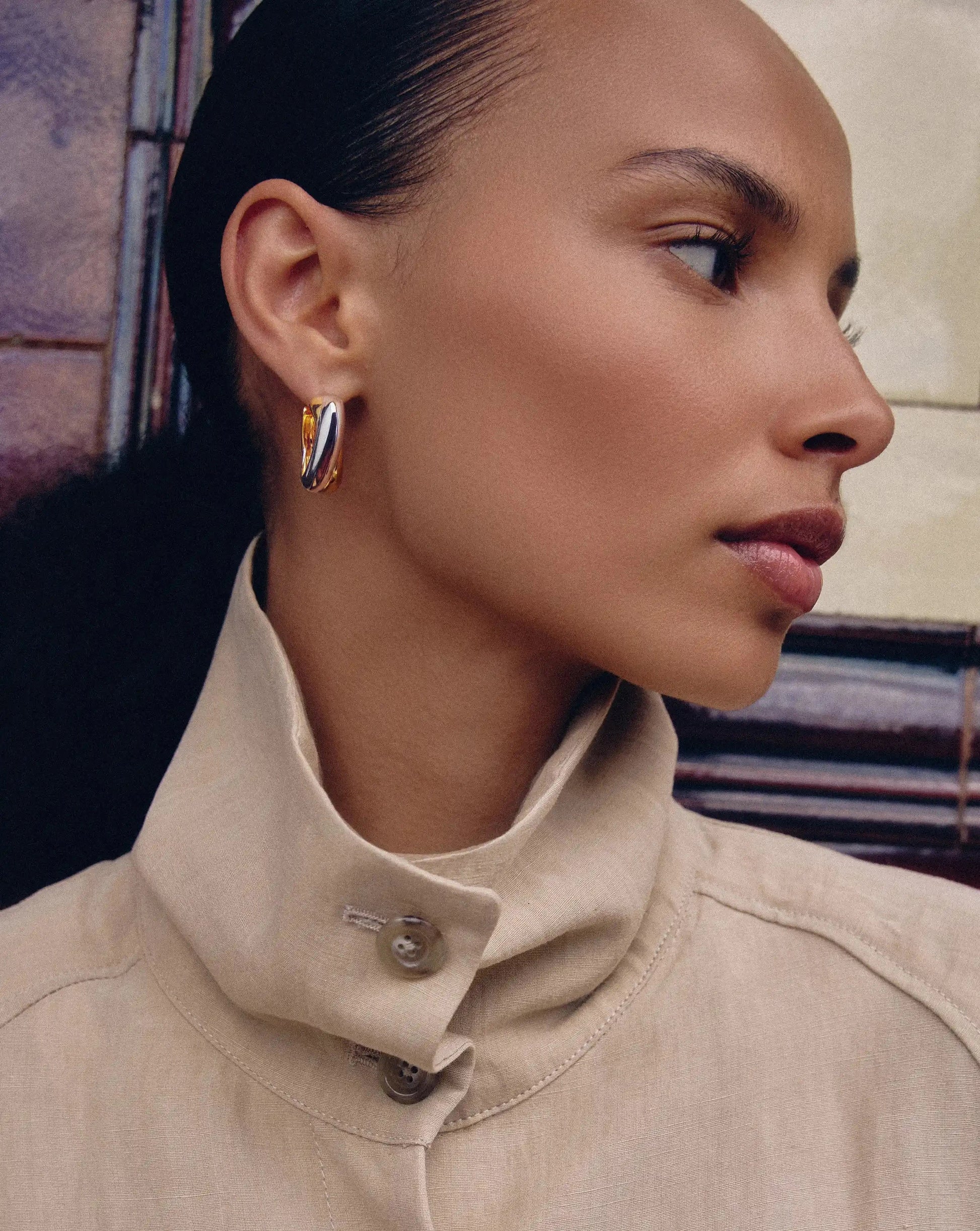 Official Missoma campaign photo of a model wearing the mixed-metal Entwine Medium Hoops